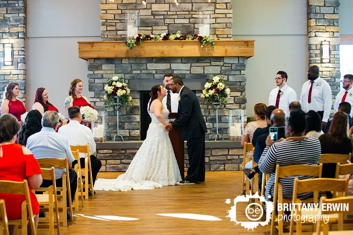 Sycamore-at-Mallow-Run-wedding-photographer-indoor-ceremony-fireplace-first-kiss.jpg
