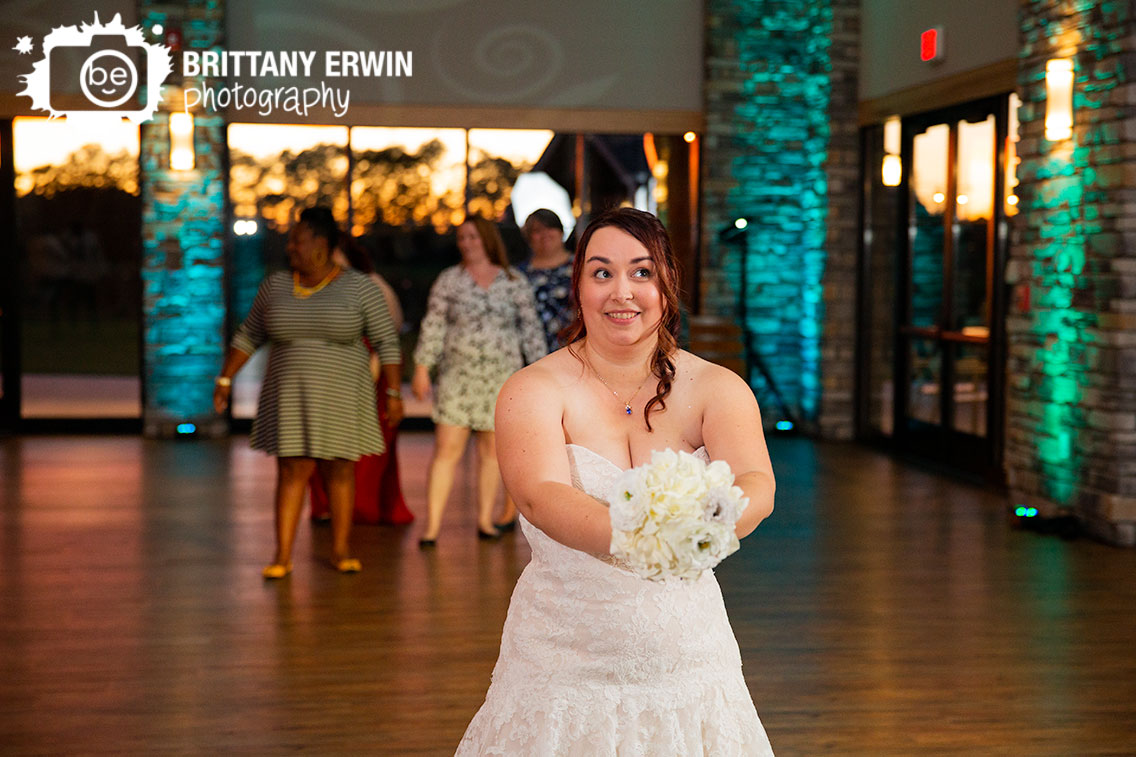 Sycamore-at-Mallow-Run-reception-photographer-bride-throwing-toss-bouquet.jpg