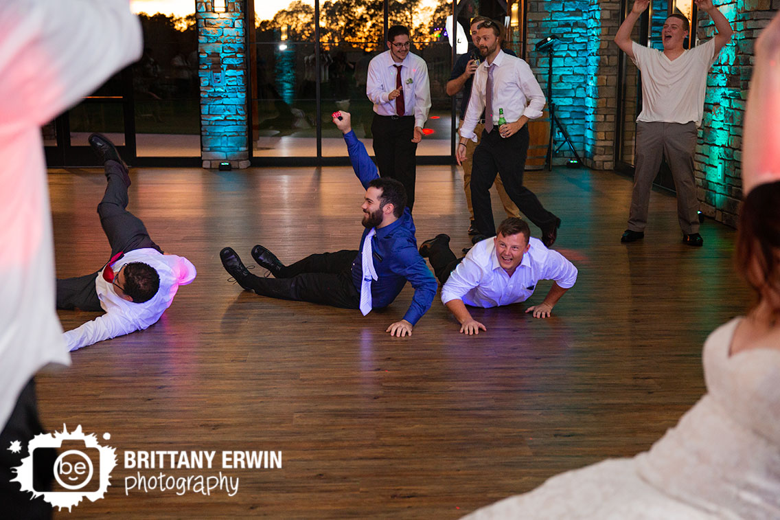 Sycamore-at-Mallow-Run-wedding-photographer-reception-garter-toss-guys-dive-on-floor.jpg