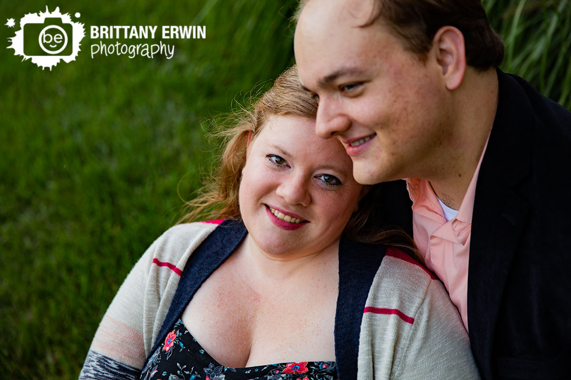 Bloomington-Indiana-engagement-portrait-photographer-couple-sit-together-in-grass.jpg