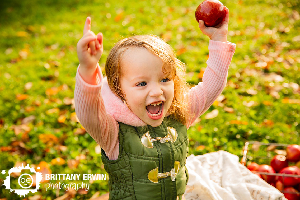 Indianapolis-fall-portrait-photographer-apple-silly-girl-toddler-outside.jpg