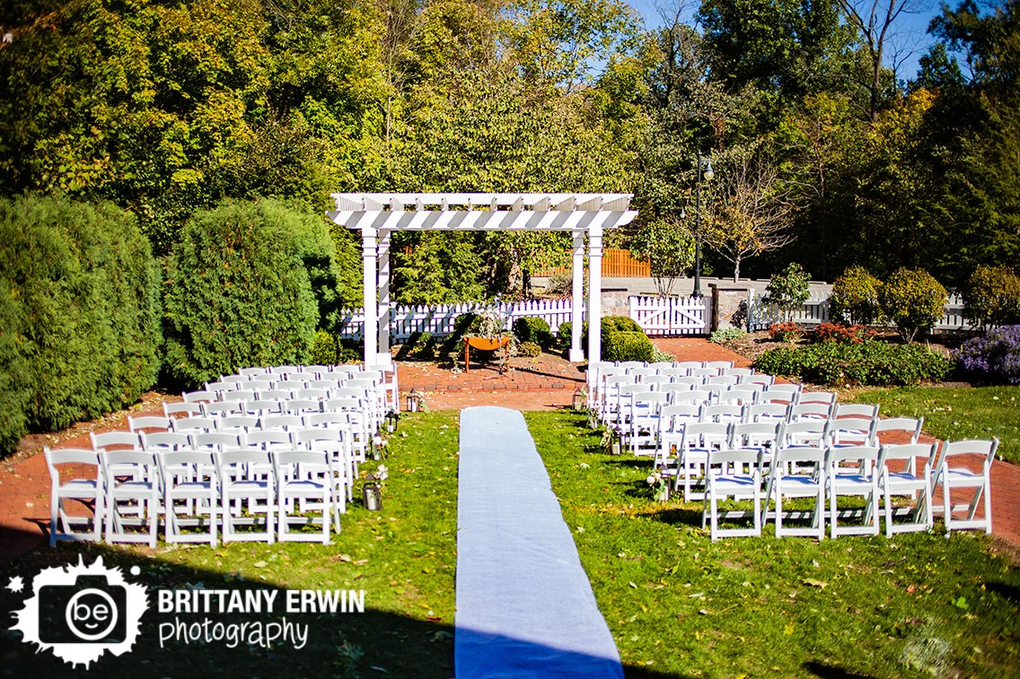 Historic-Ambassador-House-wedding-ceremony-outdoor-fall-with-flower-table-aisle-runner-lantern.jpg