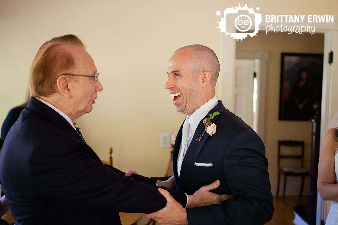 Groom-with-father-of-bride-happy-reaction-Historic-Ambassador-House.jpg