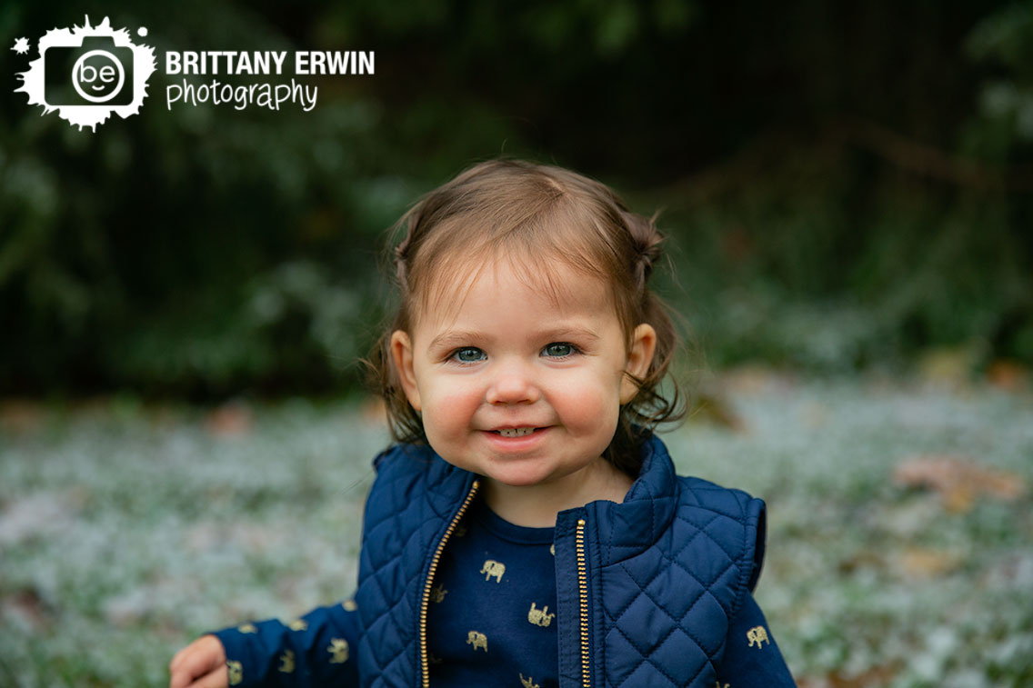 Camby-winter-snow-portrait-photographer-toddler-girl-navy-vest.jpg