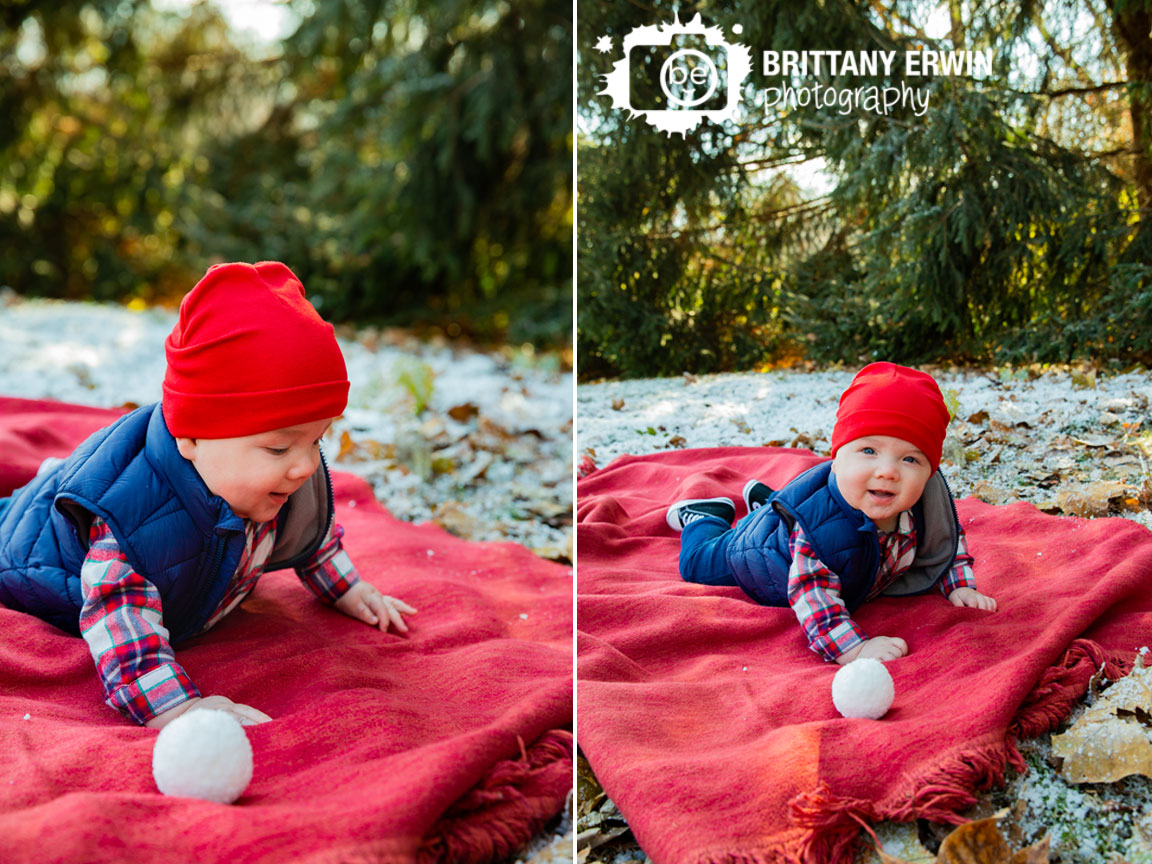 Baby-boy-on-blanket-in-snow-with-snowball-happy-mini-session.jpg