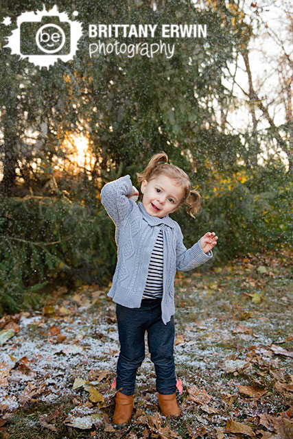 Indianapolis-snow-mini-session-photographer-girl-throwing-snow-ball-while-snowing.jpg