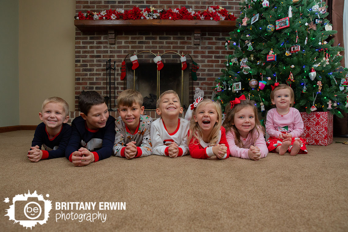 Lifestyle-christmas-portrait-photographer-in-home-cousins-with-tree-fireplace.jpg