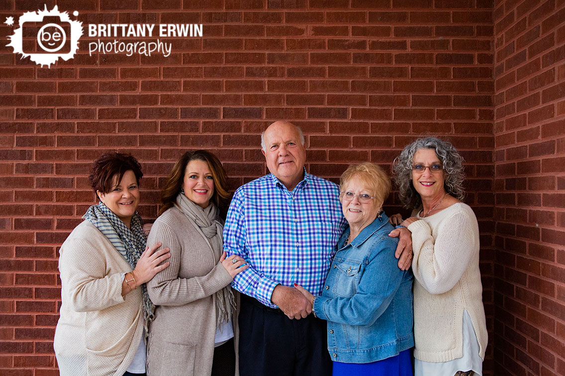 Family-portrait-sisters-with-parents-brick-wall-Franklin-Indiana-photographer.jpg