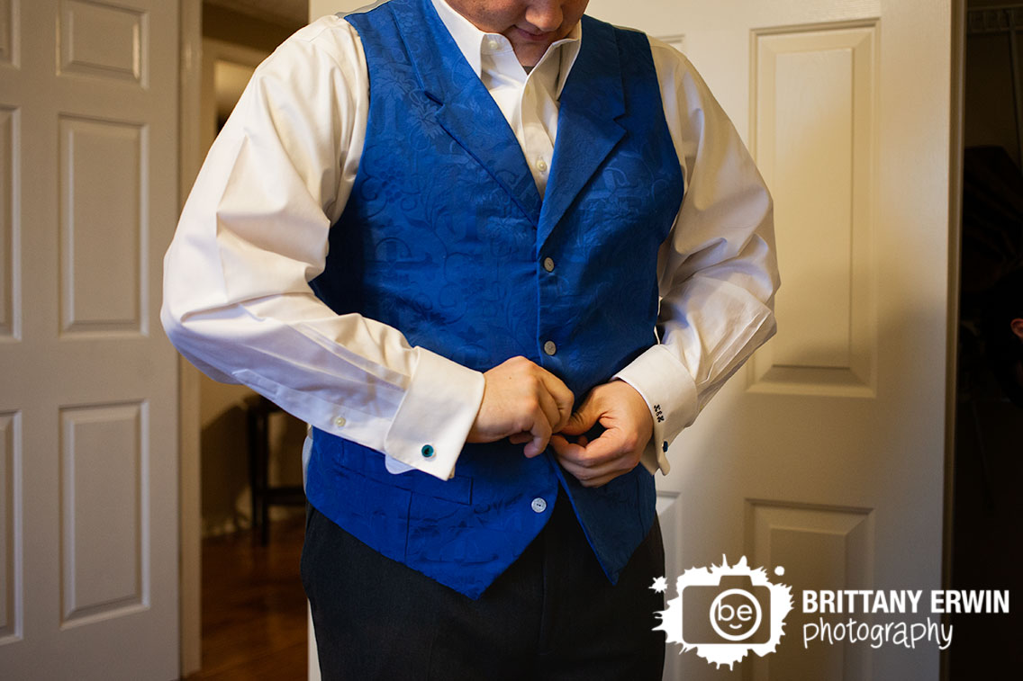 Indianapolis-wedding-photographer-groom-buttoning-vest-blue-handmade-cufflink-water-icon.jpg