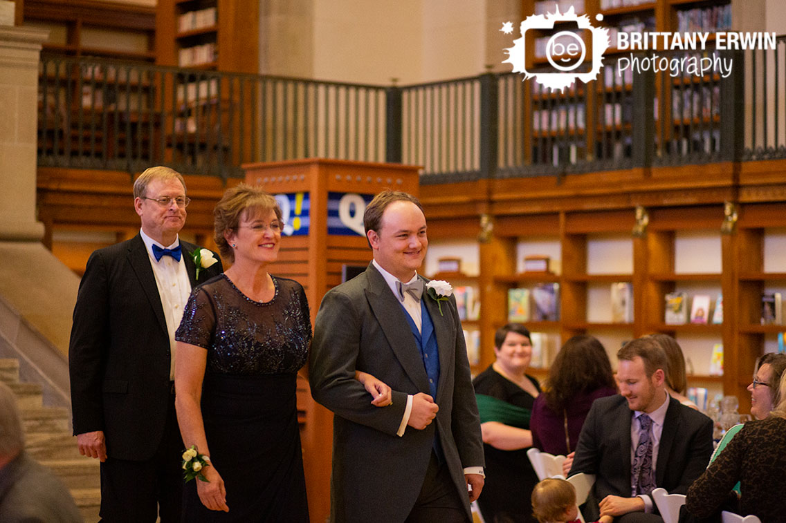 Indianapolis-central-library-wedding-ceremony-photographer-groom-walking-down-aisle-with-mother-and-father.jpg