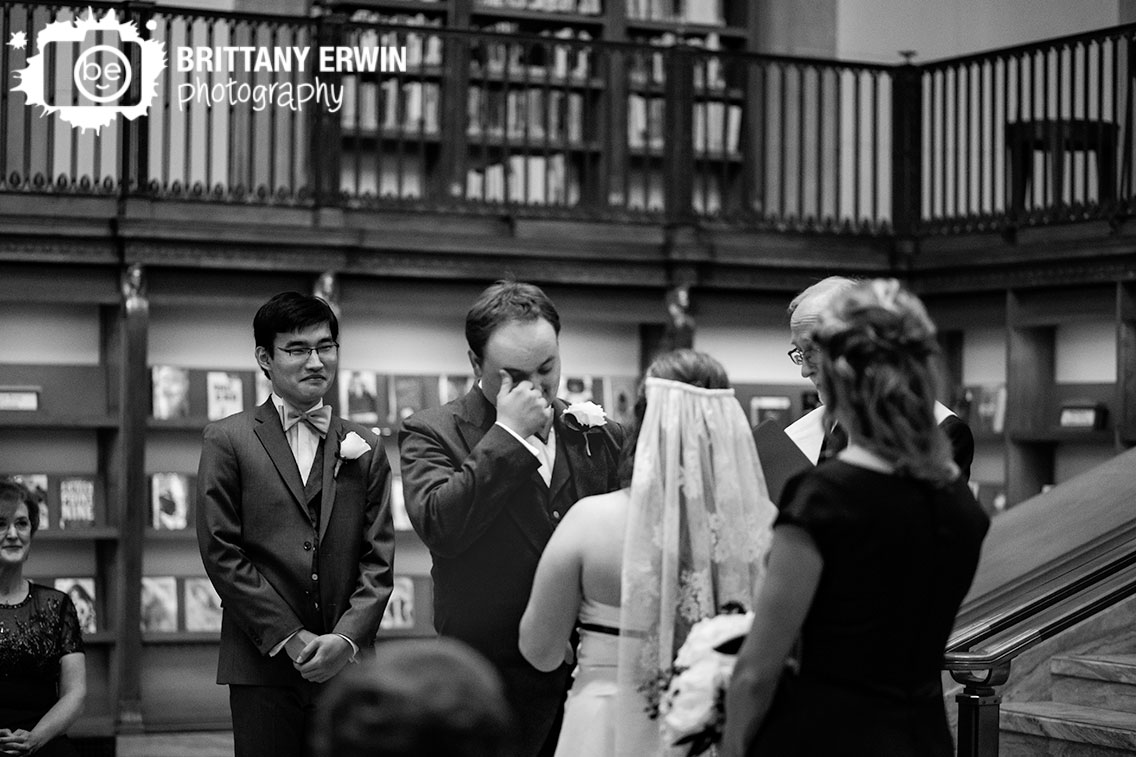 Indianapolis-central-library-wedding-ceremony-groom-wiping-eyes-emotional-couple.jpg