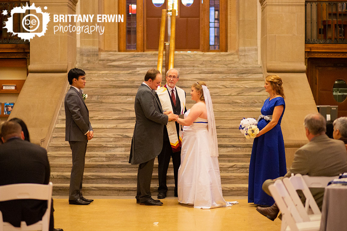 Indianapolis-wedding-photographer-central-library-ceremony-groom-ring-exchange-with-bride.jpg