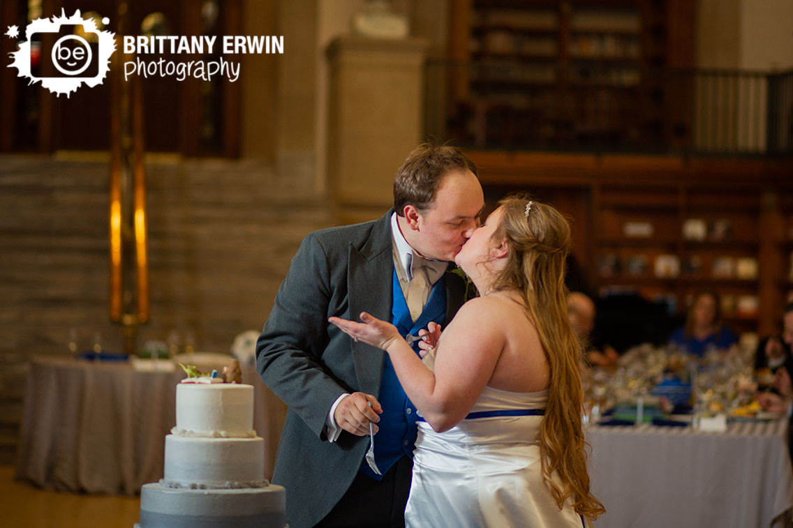 Indianapolis-central-library-wedding-reception-photographer-couple-kiss-after-cake-cutting.jpg