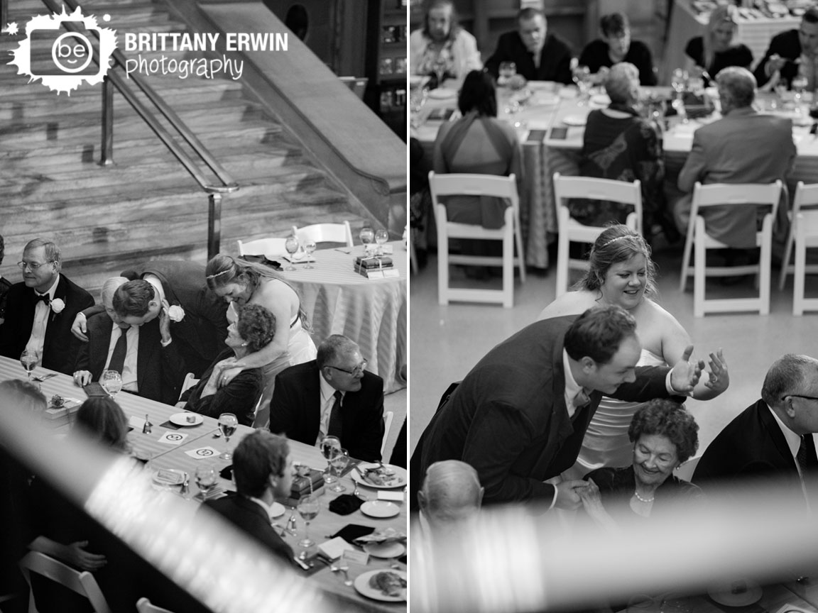 Indianapolis-Central-Library-wedding-photographer-couple-visit-tables-at-reception-hug.jpg