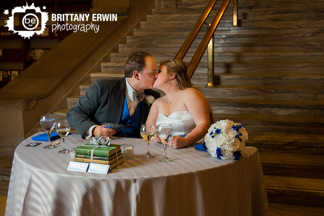 Indianapolis-Central-Library-couple-kiss-head-table-first-game-playing-cards-at-reception.jpg