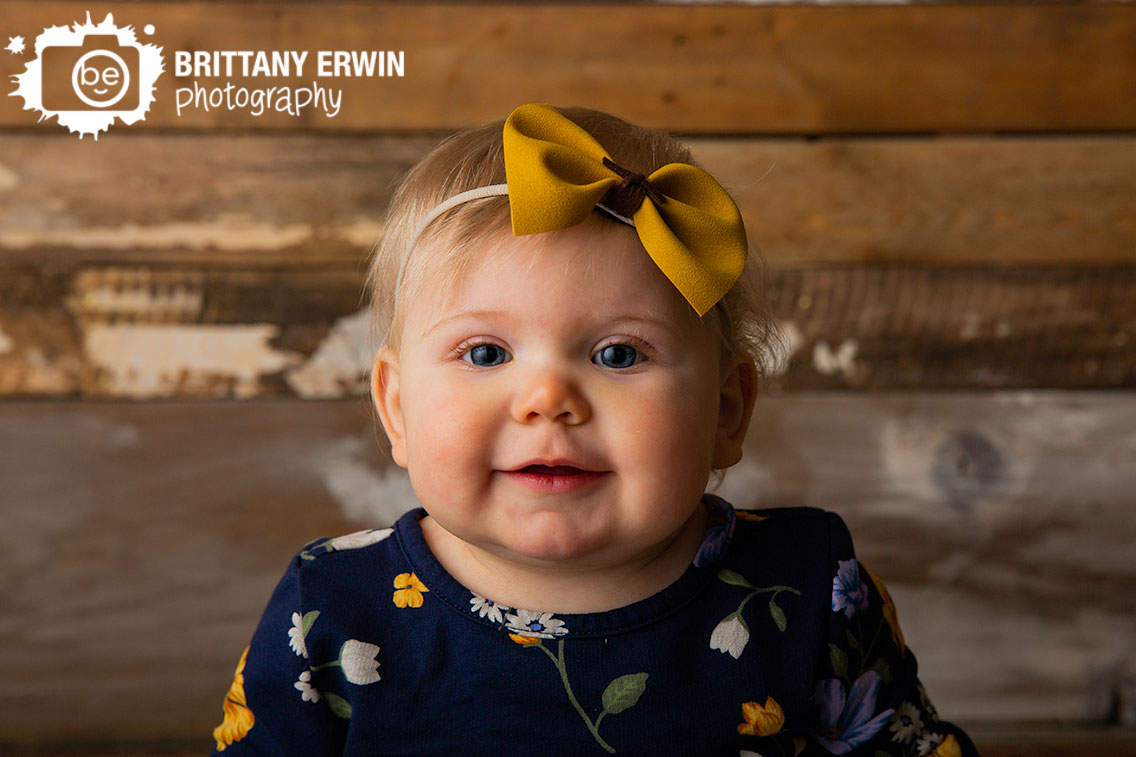 Indianapolis-studio-portrait-photographer-rustic-barn-wood-wall-baby-girl-yellow-bow-headband.jpg