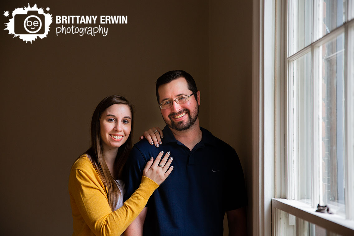 Engagement-portrait-photographer-couple-by-window-indoor-session.jpg