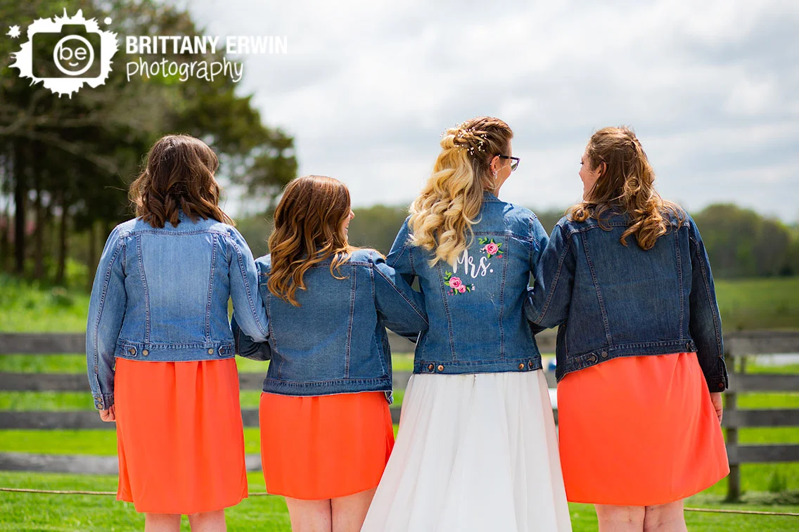 bride-with-bridesmaids-jean-jacket-group-Mrs-flower-on-back.jpg