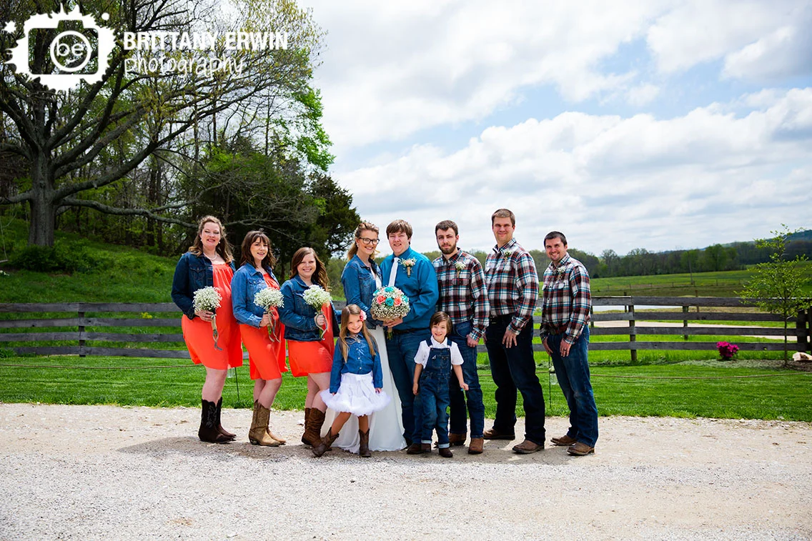 Wedding-bridal-party-group-portrait-outside-rustic-gatherings-barn-venue.jpg