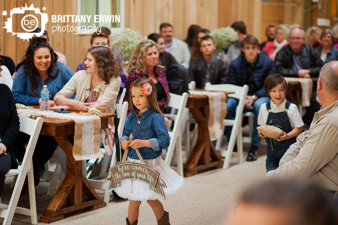 flower-girl-ring-bearer-walking-down-aisle-rustic-gatherings-barn-venue.jpg