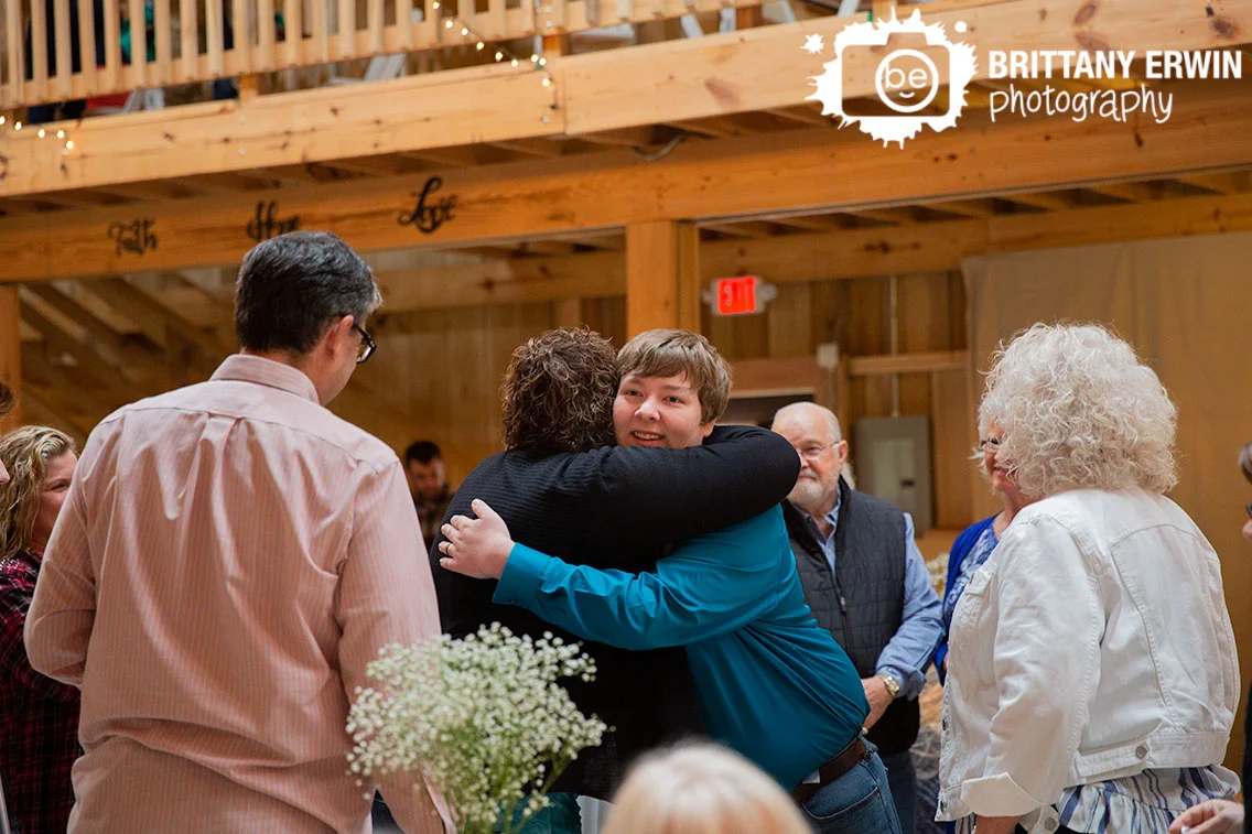 groom-greeting-guests-after-wedding-ceremony-release-by-row.jpg