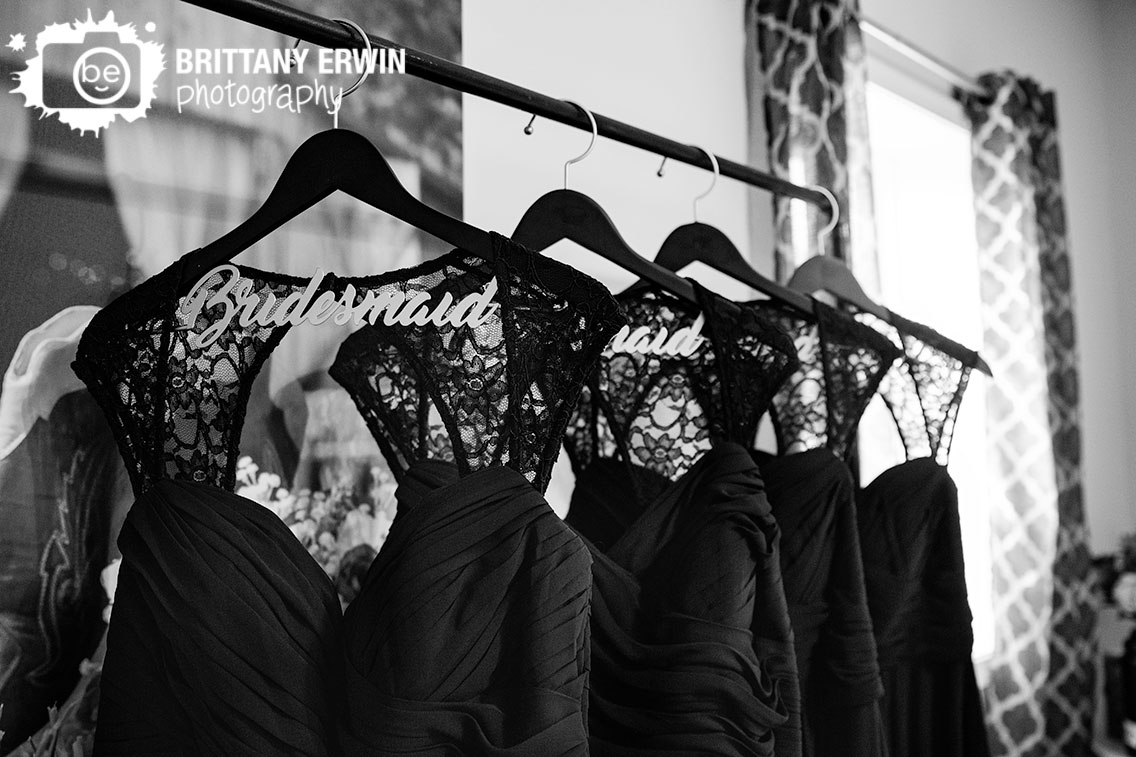 bridesmaid-hanging-dresses-in-line-on-pipe-custum-hangers.jpg