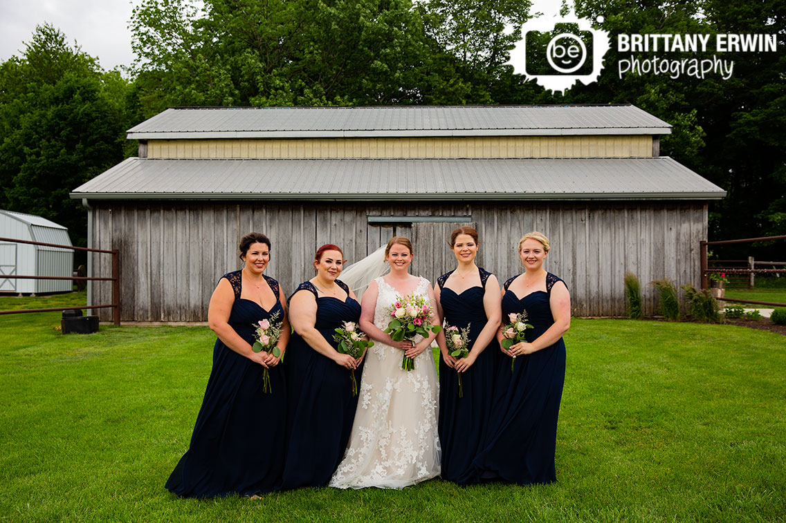 Indiana-wedding-photographer-bride-bridesmaids-portrait-in-front-of-barn.jpg