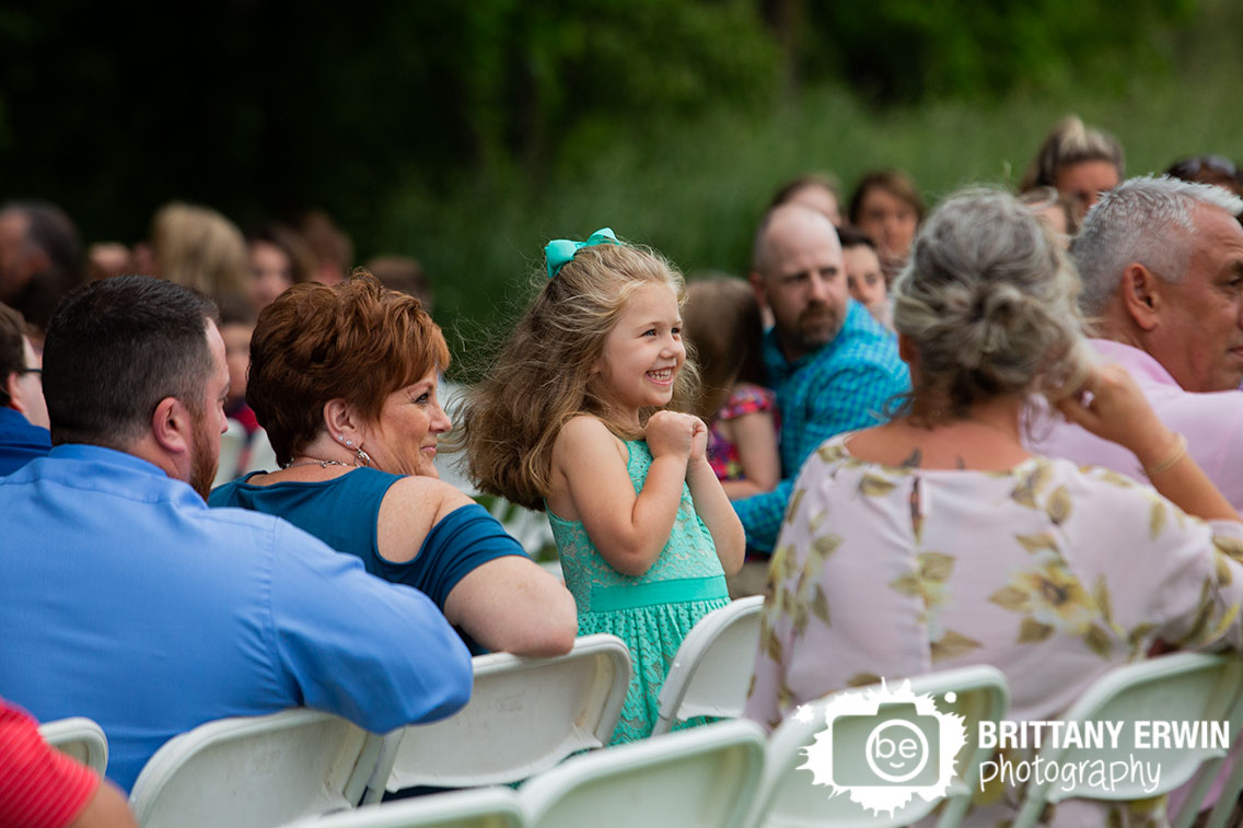 little-girl-in-seats-excited-at-wedding-ceremony.jpg