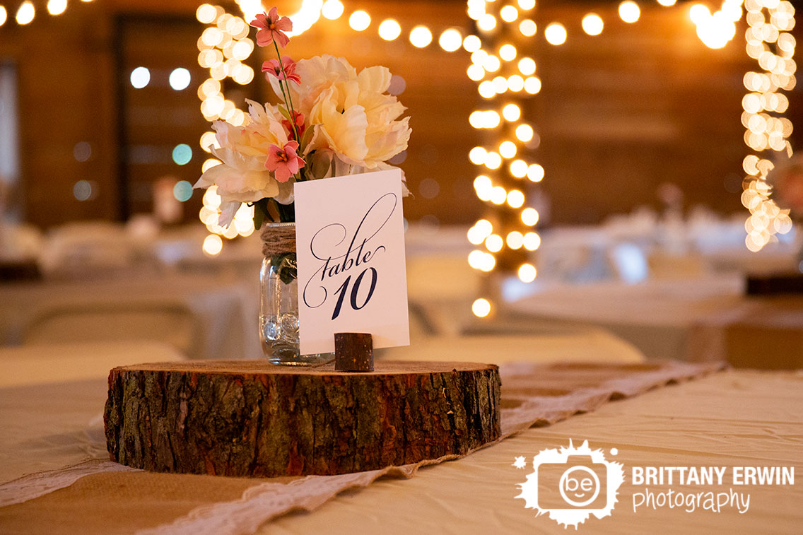 table-number-flower-centerpiece-twinkle-lights-barn-venue.jpg
