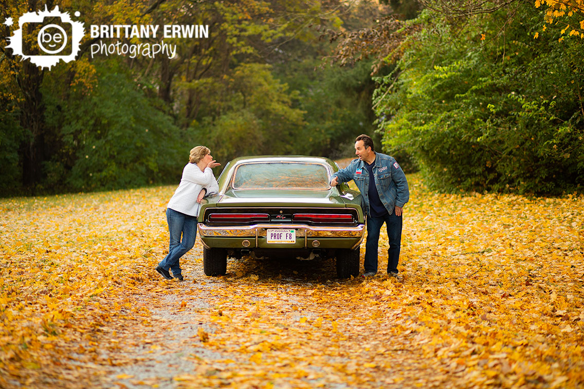 Indianapolis-portrait-photographer-fall-leaves-gravel-drive-blowing-kiss.jpg