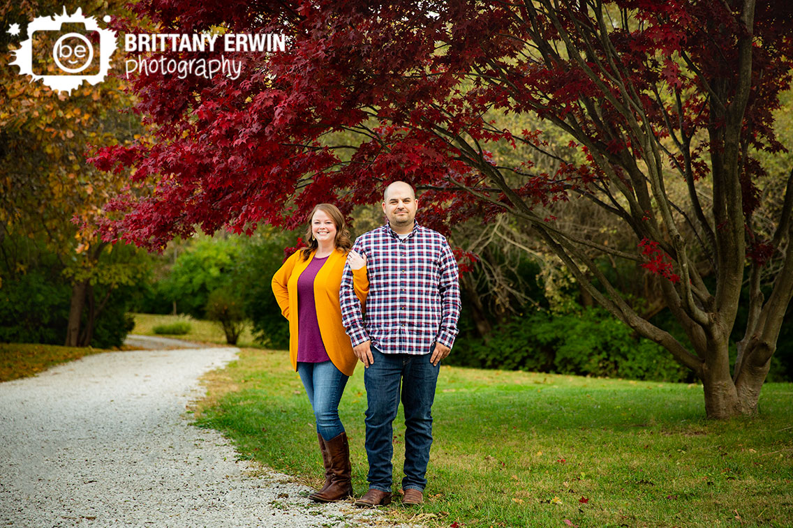 Camby-Fall-engagement-portrait-photographer-couple-under-japenese-maple-red-leaves-path.jpg