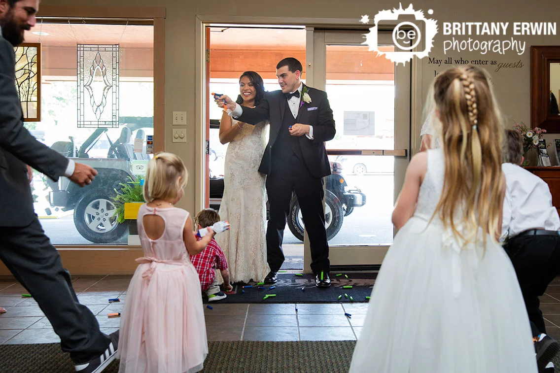 bride-and-groom-enter-reception-nerf-guns-with-kids.jpg