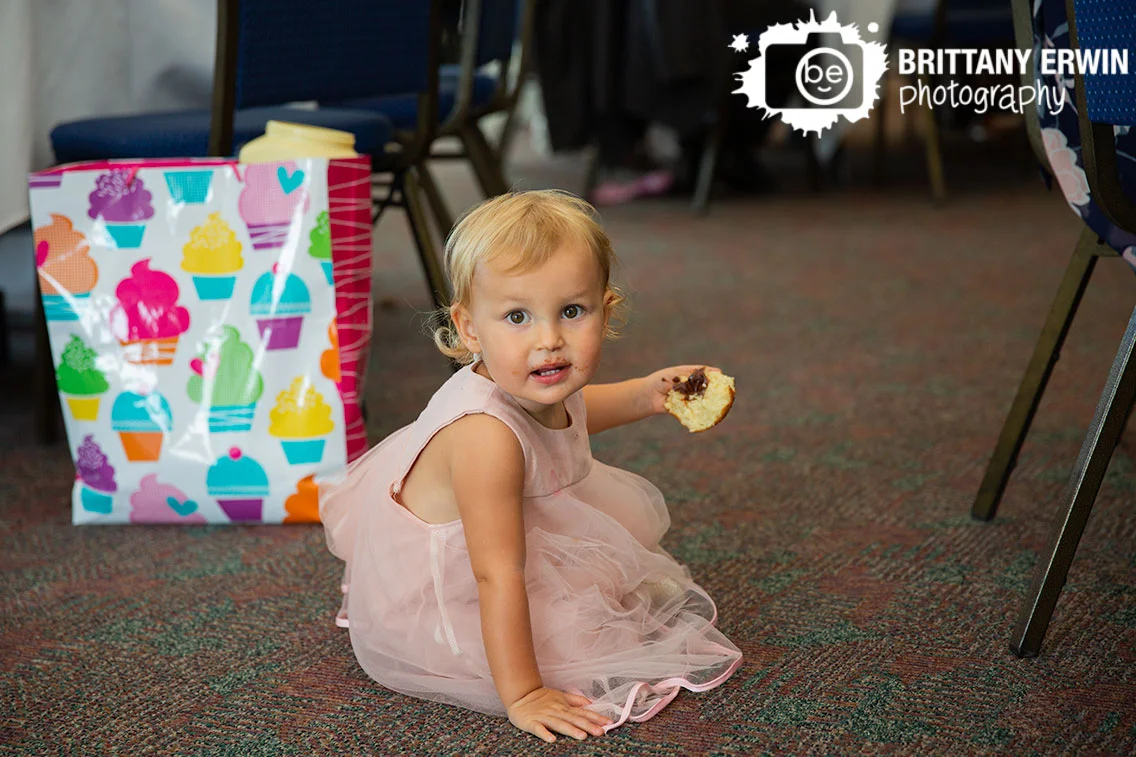 little-girl-eating-donut-messy-face-wedding-reception.jpg