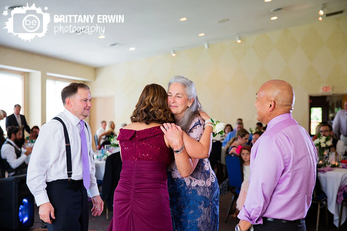 mother-of-bride-and-groom-hug-before-anniversary-dance.jpg