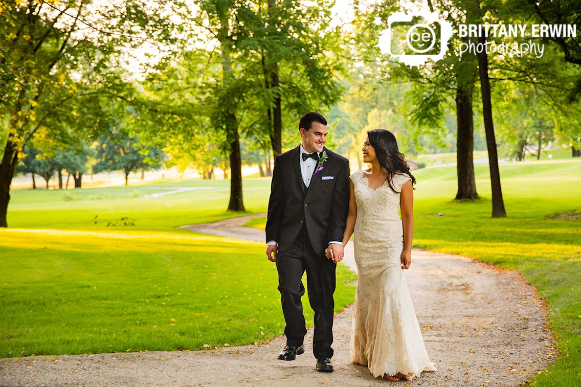 bride-groom-walk-down-path-sunset-Salt-Creek-Golf-Resort.jpg