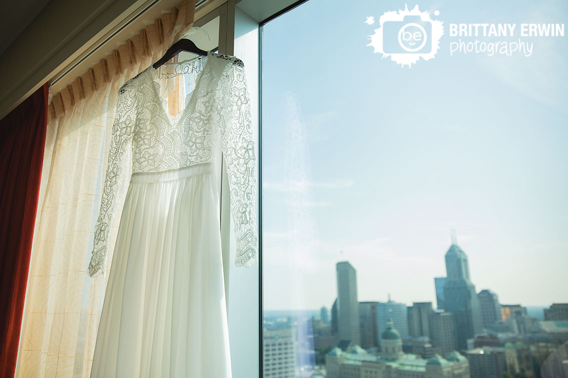 custom-hanger-bridal-gown-dress-lace-sleeves-hanging-in-window-JW-Marriott-skyline-Indianapolis.jpg