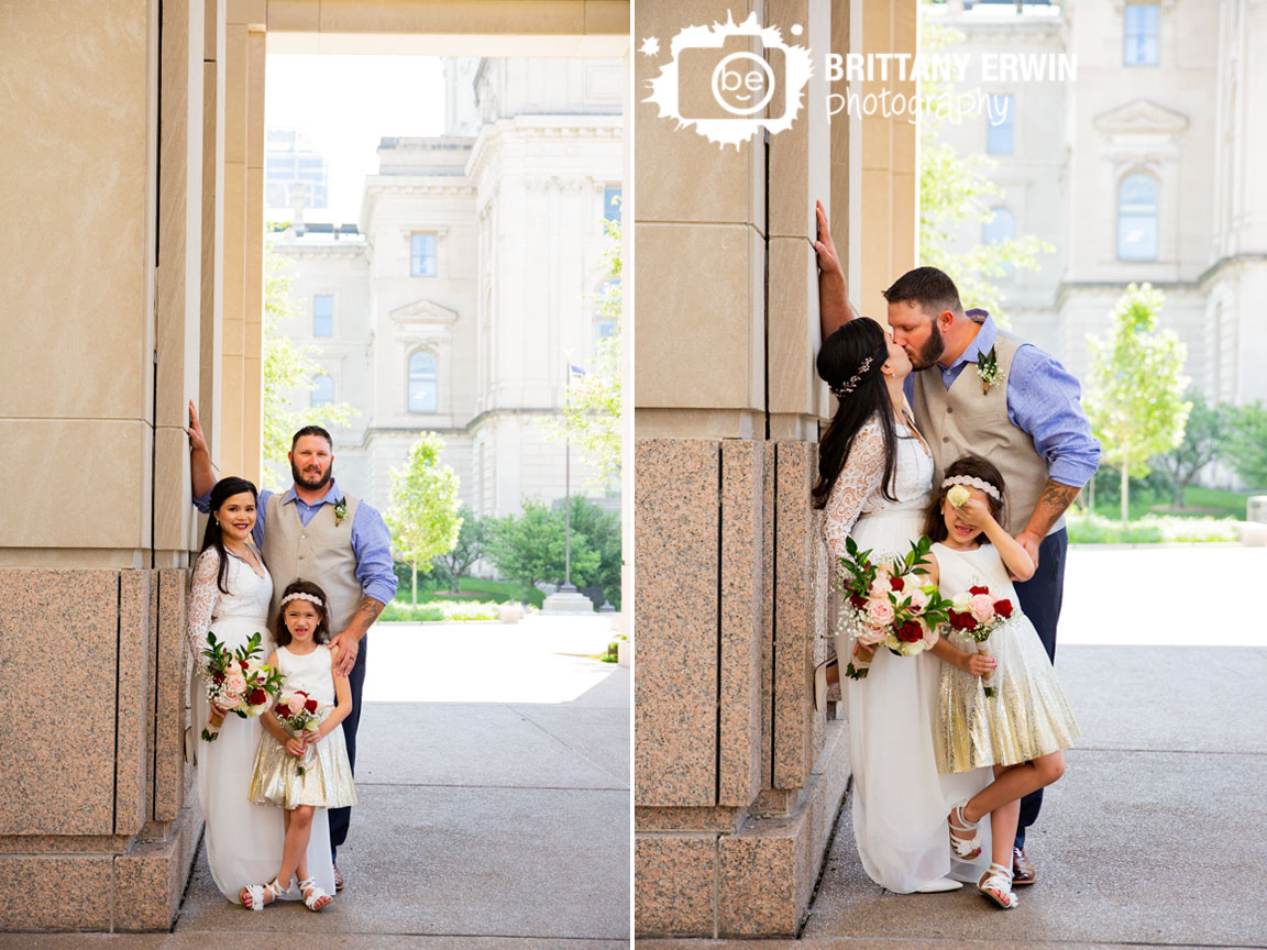 Indianapolis-elopement-photographer-couple-kiss-by-state-house-daughter-cover-eyes.jpg