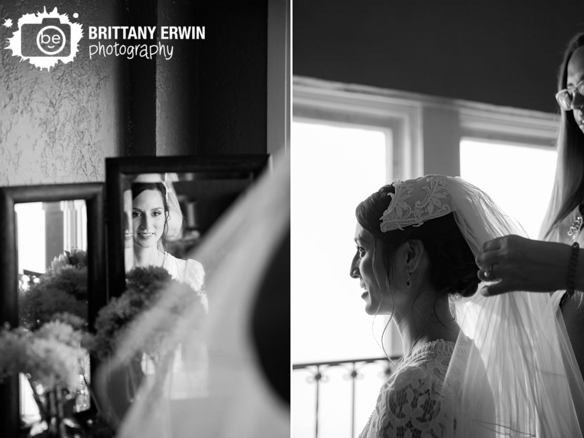 Bride-getting-ready-putting-on-veil-in-mirror.jpg