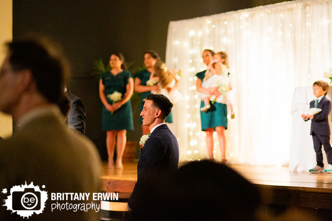 Groom-reaction-as-bride-walks-down-aisle-at-wedding-ceremony.jpg