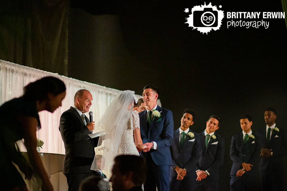 Wedding-ceremony-groom-laughing-at-altar-on-stage.jpg