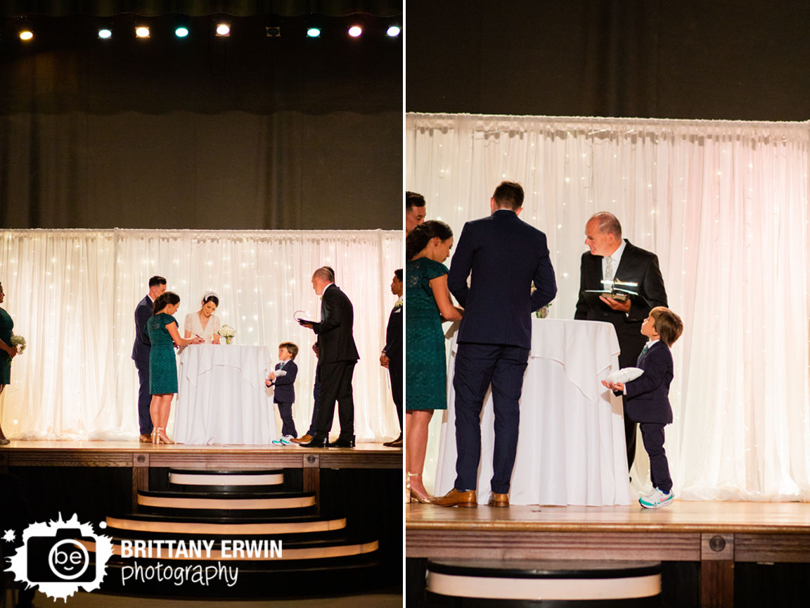 Wedding-ceremony-photographer-bride-groom-sign-marriage-license-ring-bearer-peek-over-table.jpg