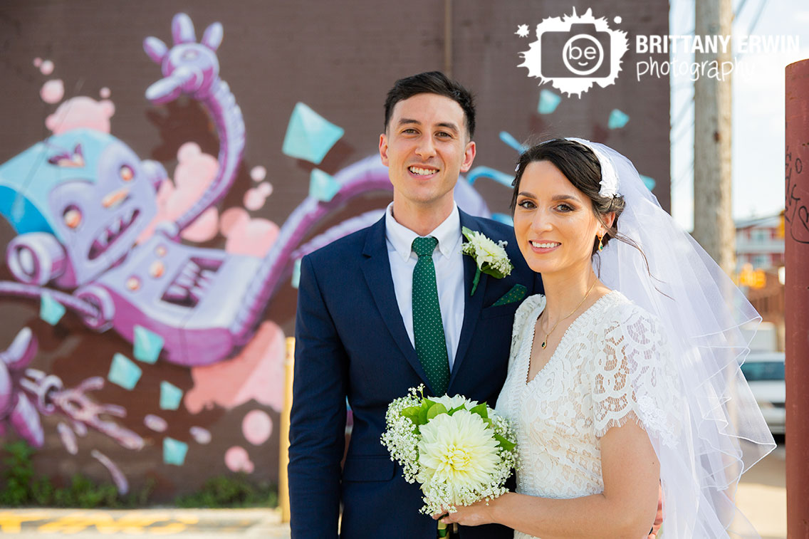 Fountain-Square-Indiana-wedding-photographer-couple-with-mural-robot-painting.jpg