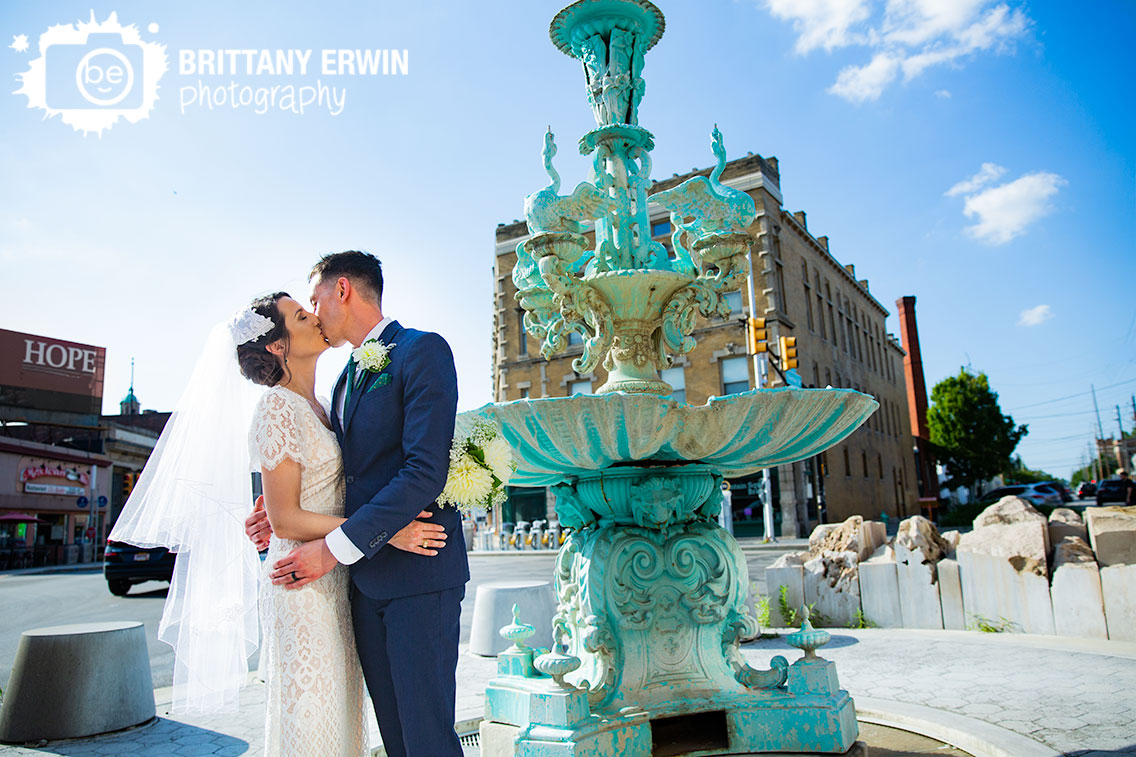 Fountain-Square-Indiana-wedding-photographer-couple-at-the-fountain-kiss-with-city.jpg