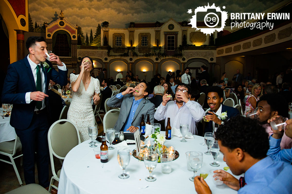 Wedding-reception-couple-at-table-shots-tequila-lime.jpg