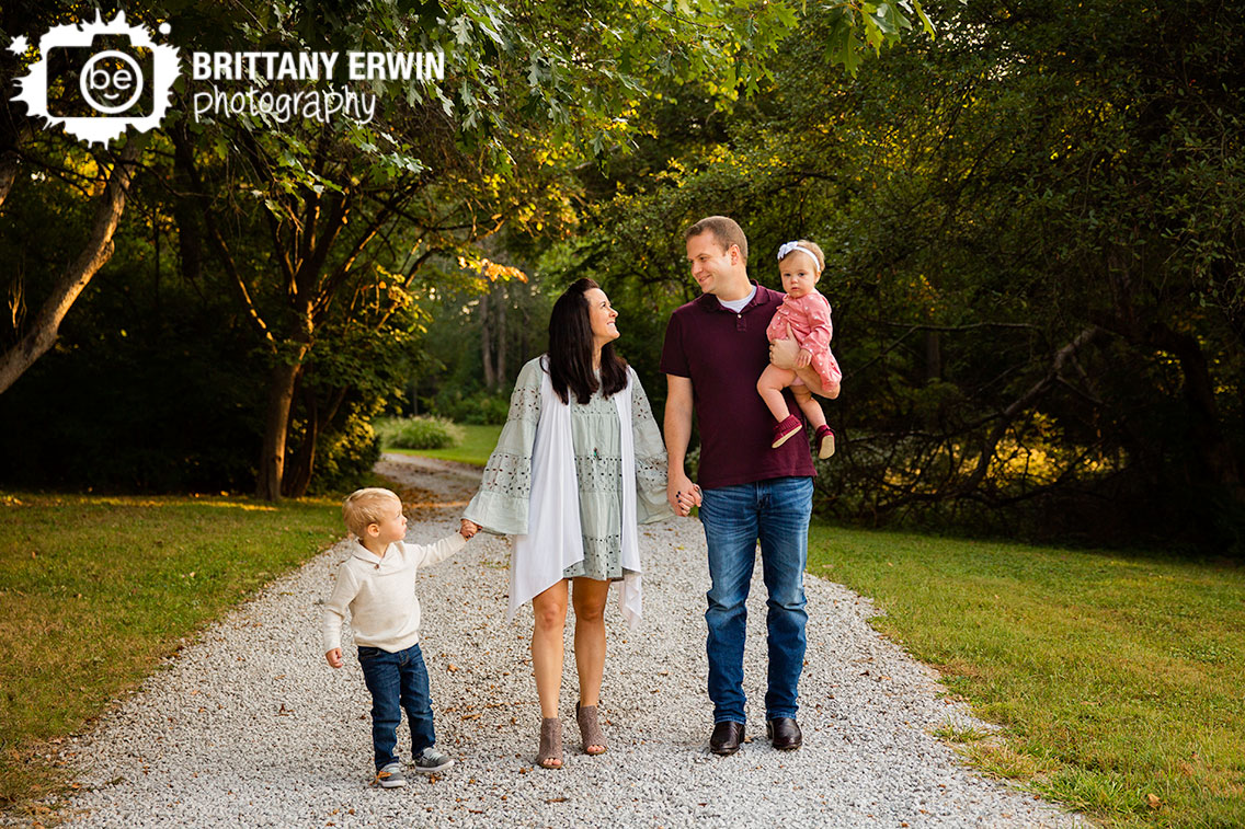 Indianapolis-family-portrait-photographer-husband-wife-with-son-daughter-walking-down-gravel-path.jpg