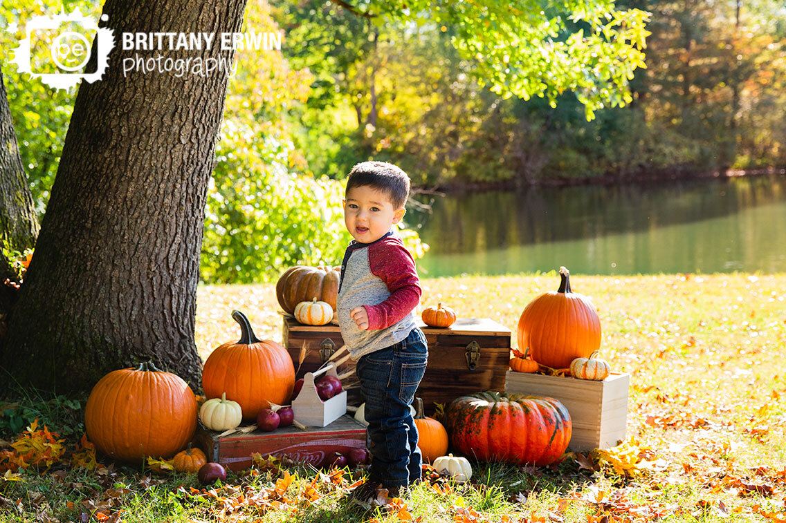 Indianapolis-fall-portrait-photographer-boy-with-pumpkins-by-pond-at-sunrise.jpg