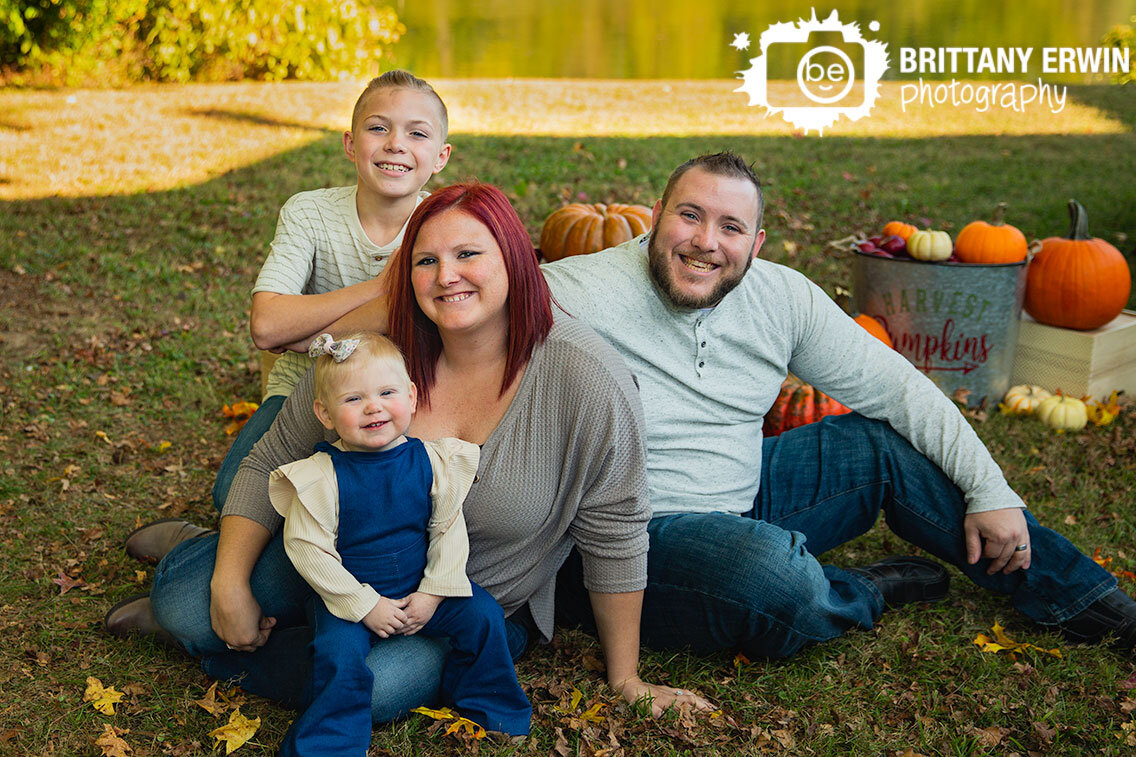 Family-portrait-brother-sister-pumpkins-by-pond.jpg