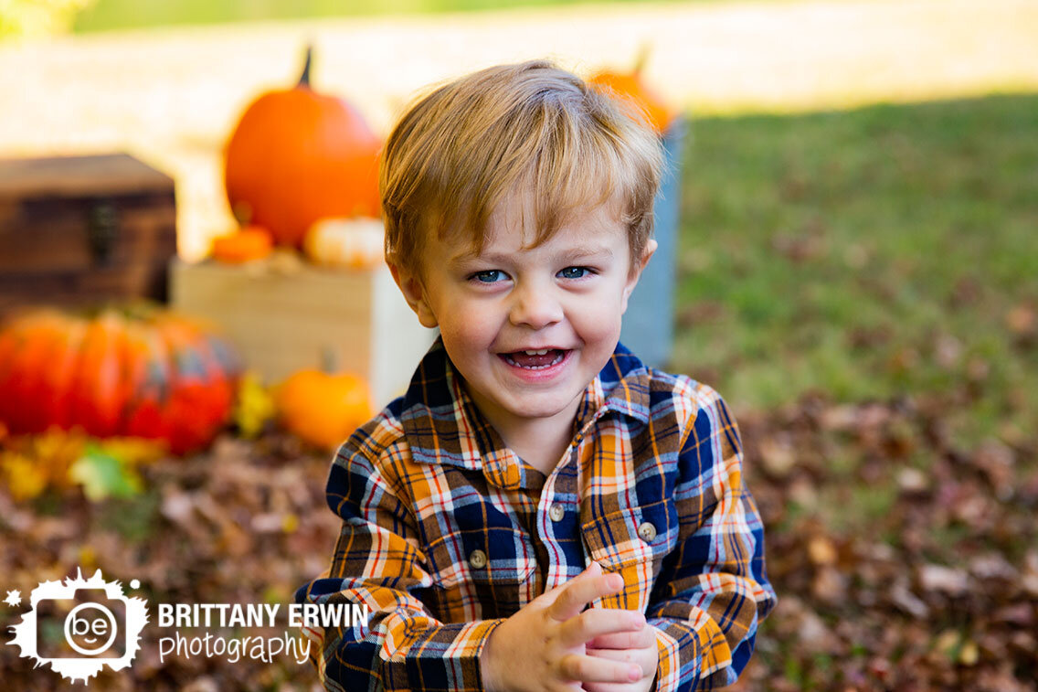 Fall-mini-session-photographer-toddler-boy-pumpkins-silly.jpg