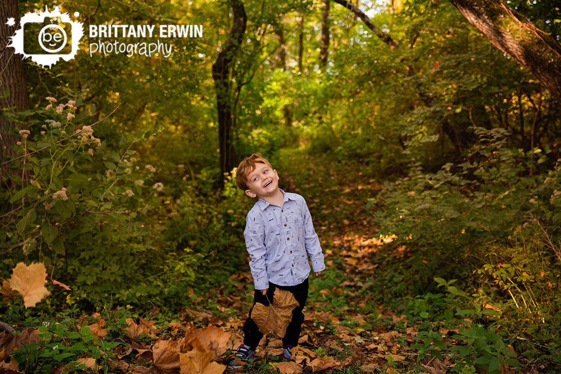 Indianapolis-boy-playing-in-fall-leaves.jpg