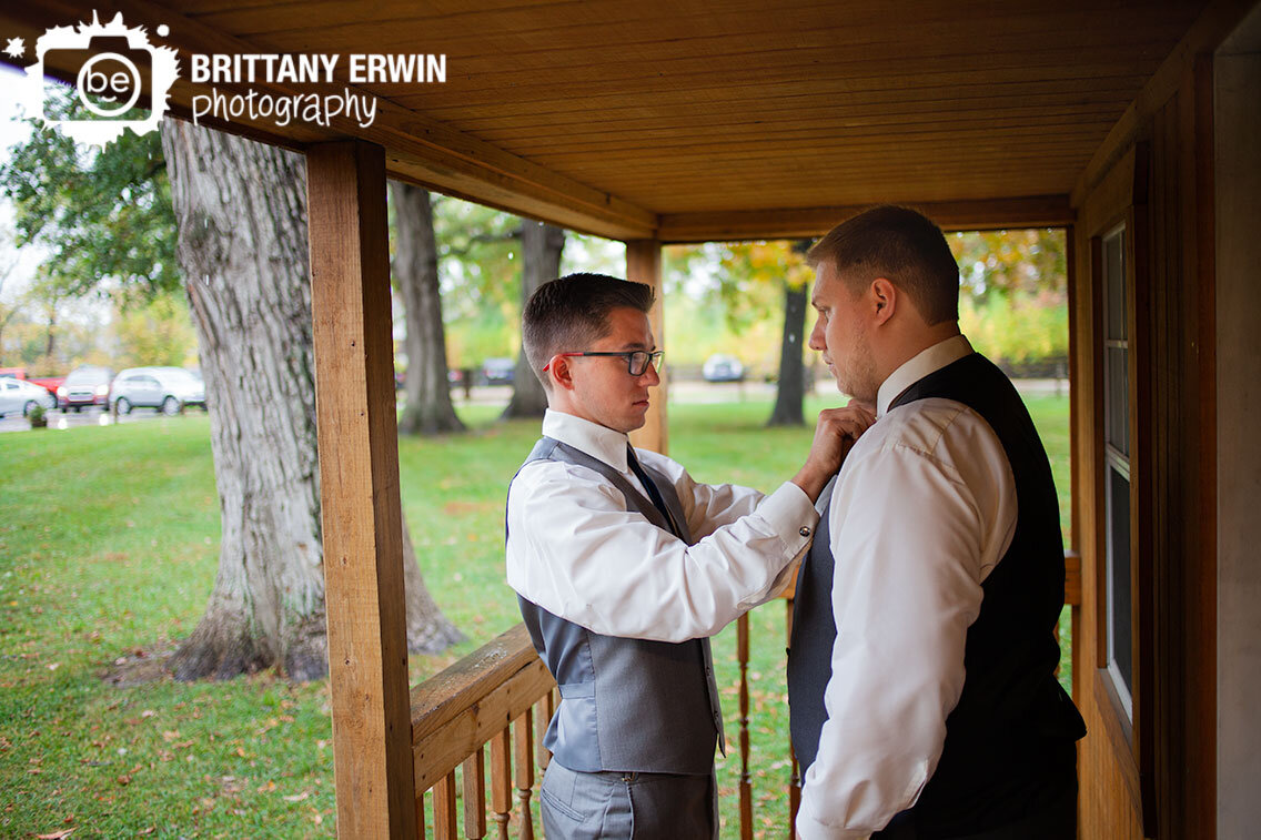 groom-getting-ready-best-man-groomsman-straighten-tie.jpg